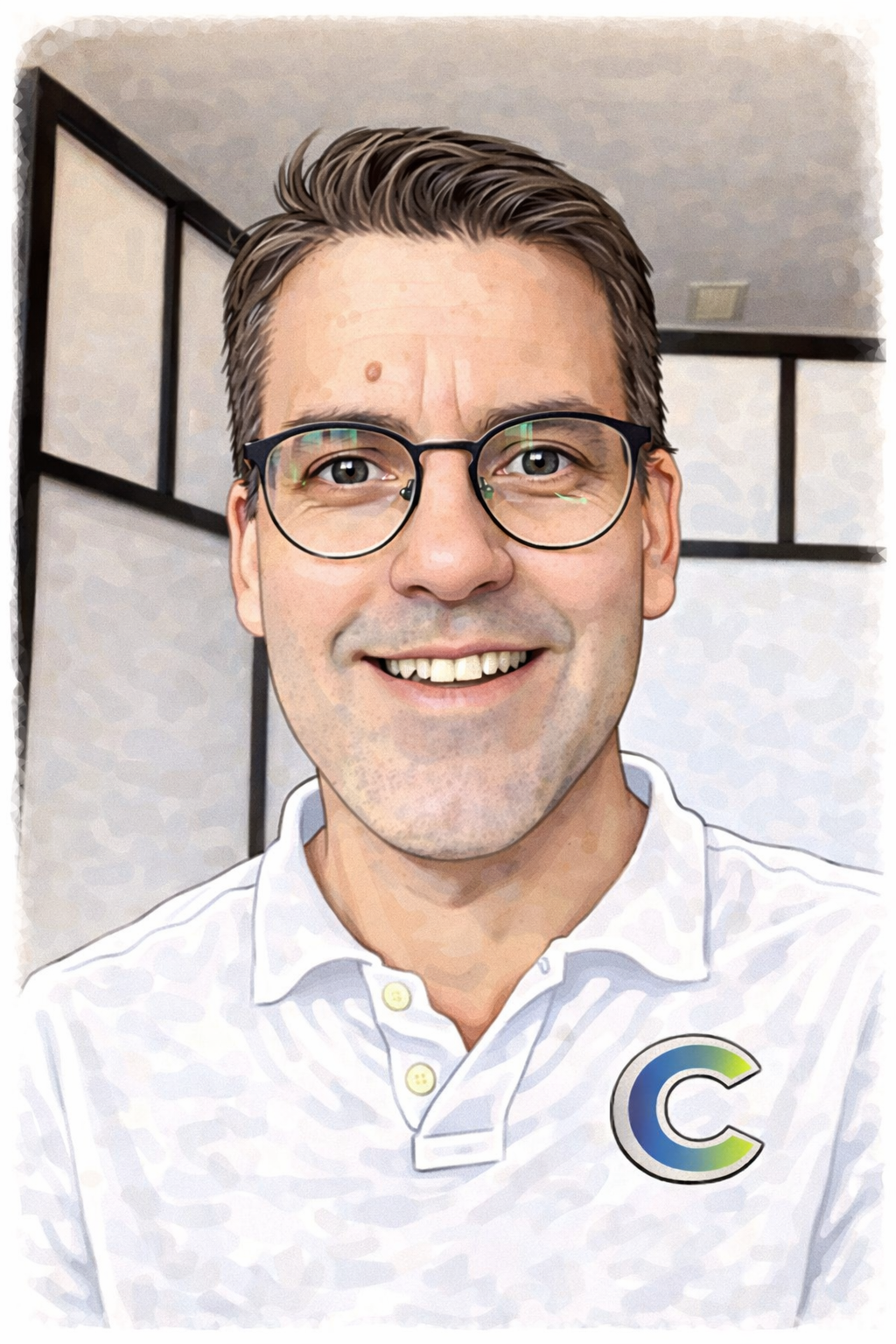 A smiling man with short dark hair, glasses, and a white collared shirt with a circular logo on the chest, standing in front of a partitioned wall.