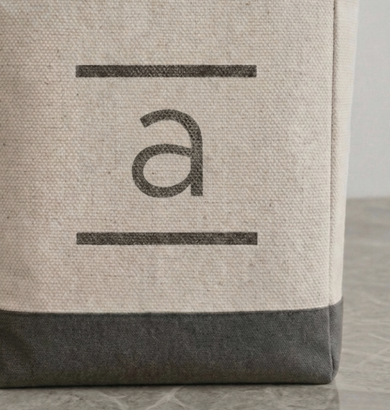 Good-e-bag close up of hand-stamped personalised monogrammed initial in eco-friendly  ink on canvas bag. AI generated image.