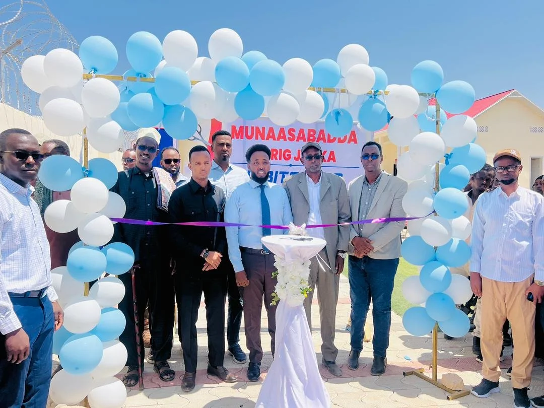 Awale leadership members celebrating the opening of the hospital surrounded by balloons and ribbons