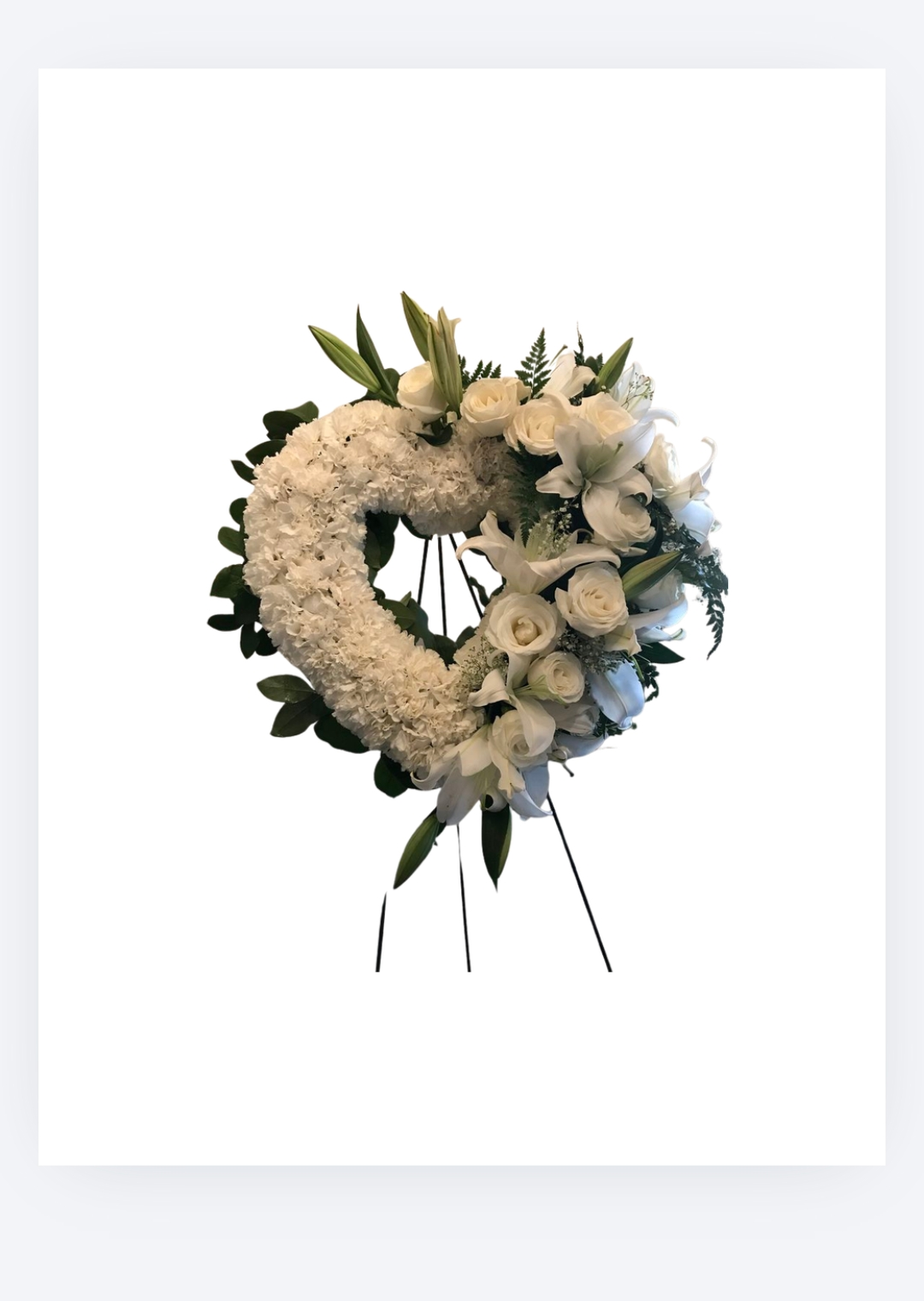 White floral wreath featuring lilies, roses, and greenery