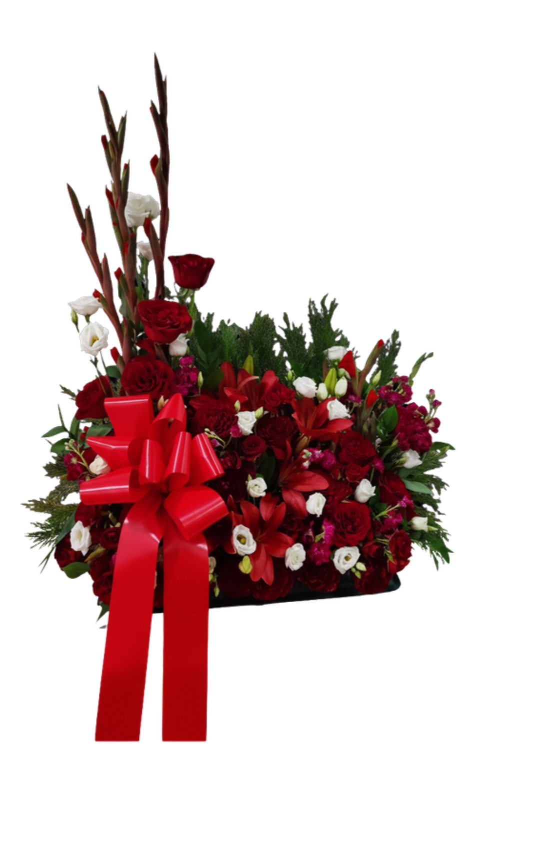 A floral arrangement with red, white, and pink flowers, decorated with a large red bow.