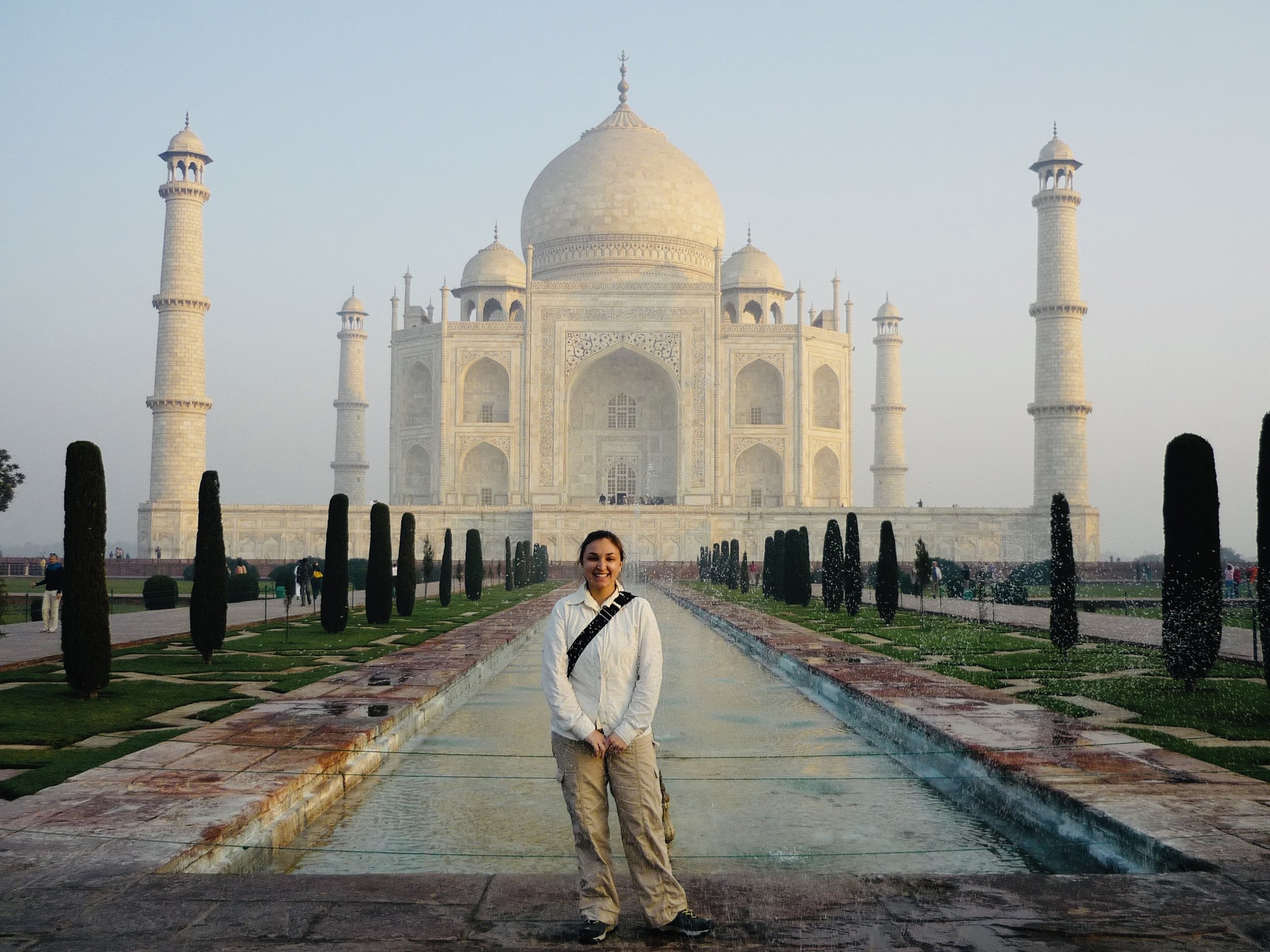 Tanya Hartman standing in front of the Taj Mahal in India.