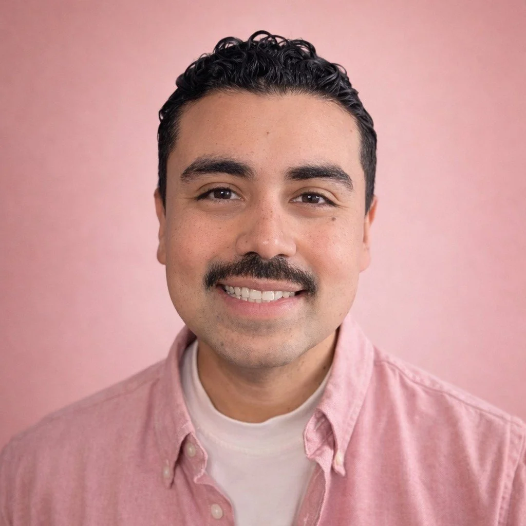 Studio Headshot of Founder, Fernando. Looking straight to   camera, big smile, wearing pink