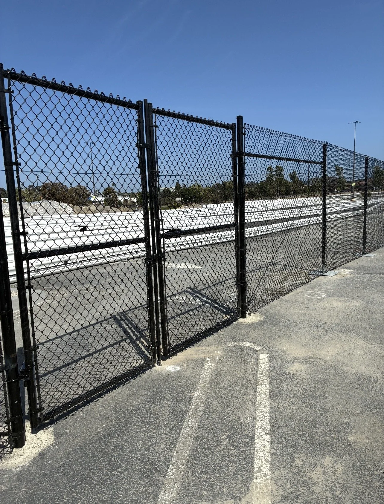 Commercial chain link perimeter fence securing industrial property