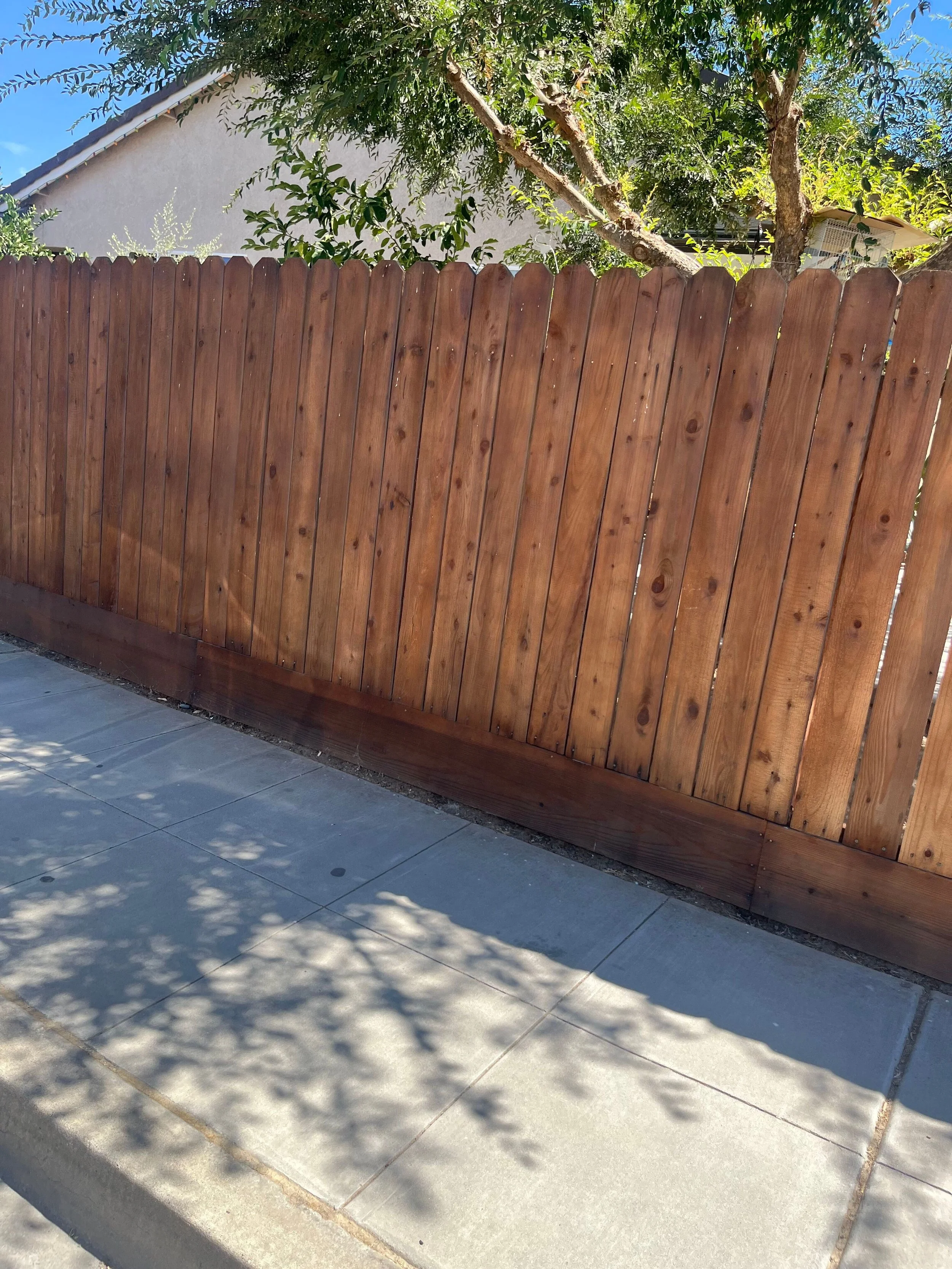 Wood privacy fence installed along residential property line for screening