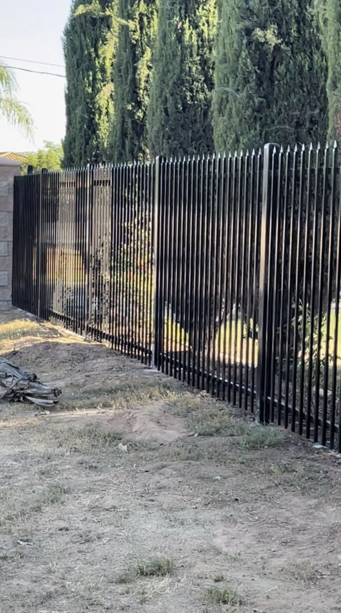 Black ornamental iron security fence installed for commercial perimeter protection