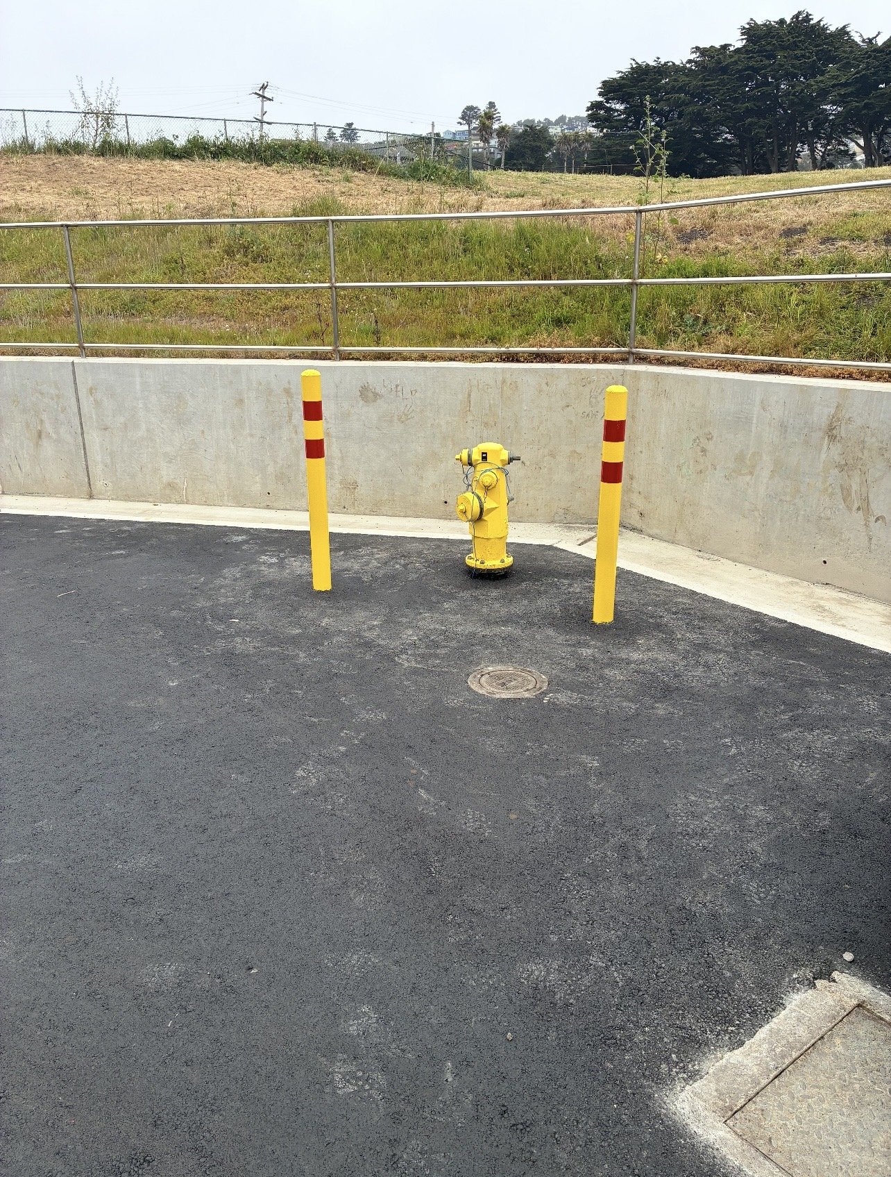 Protective safety bollards installed around fire hydrant infrastructure