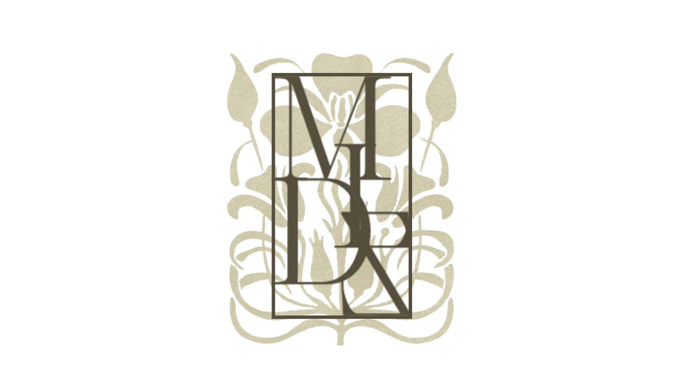 A decorative clock with an ornate black frame and gold-colored detailing, featuring clock hands pointing to 12:00.