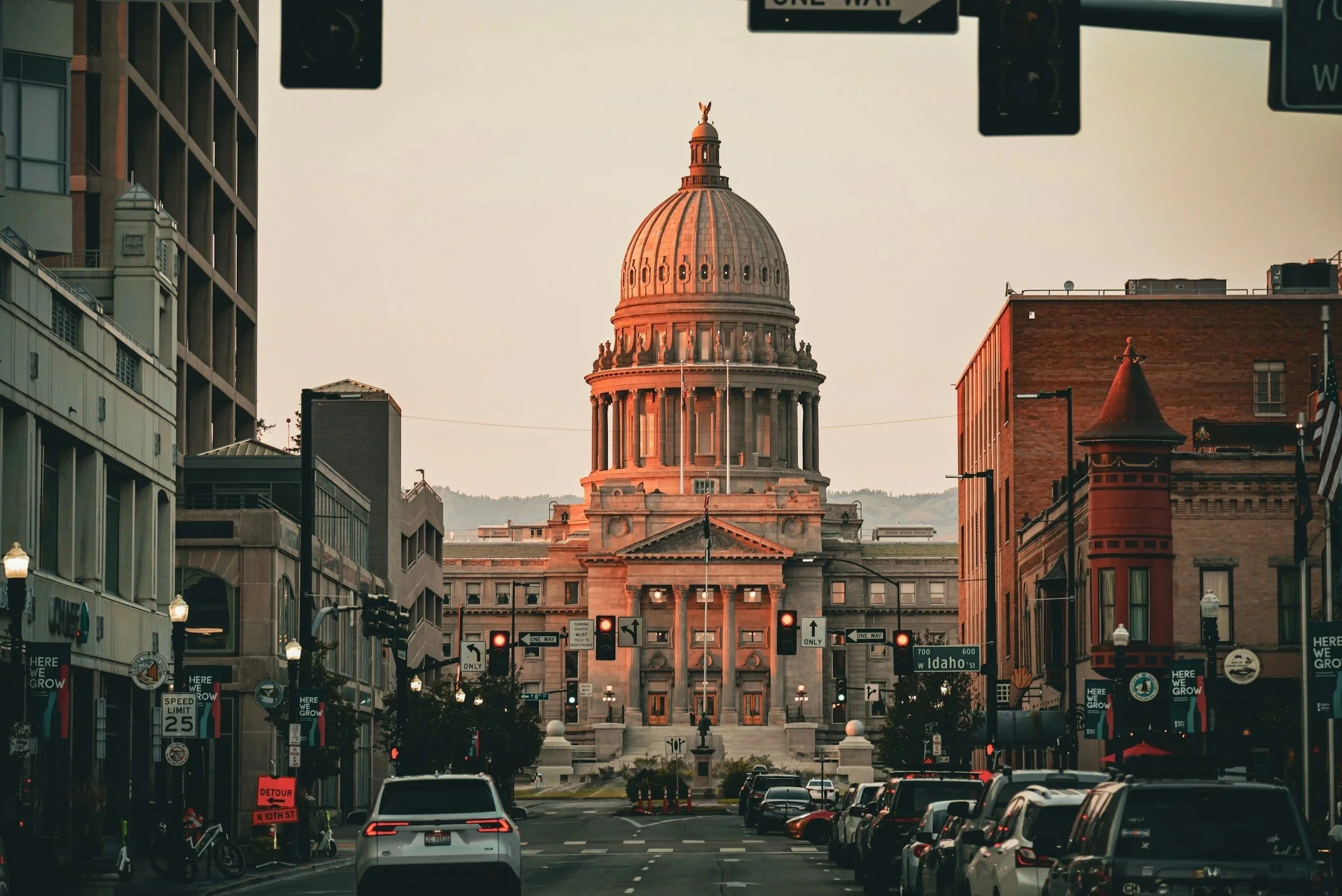 The Idaho Captiol building from street view under a sunset