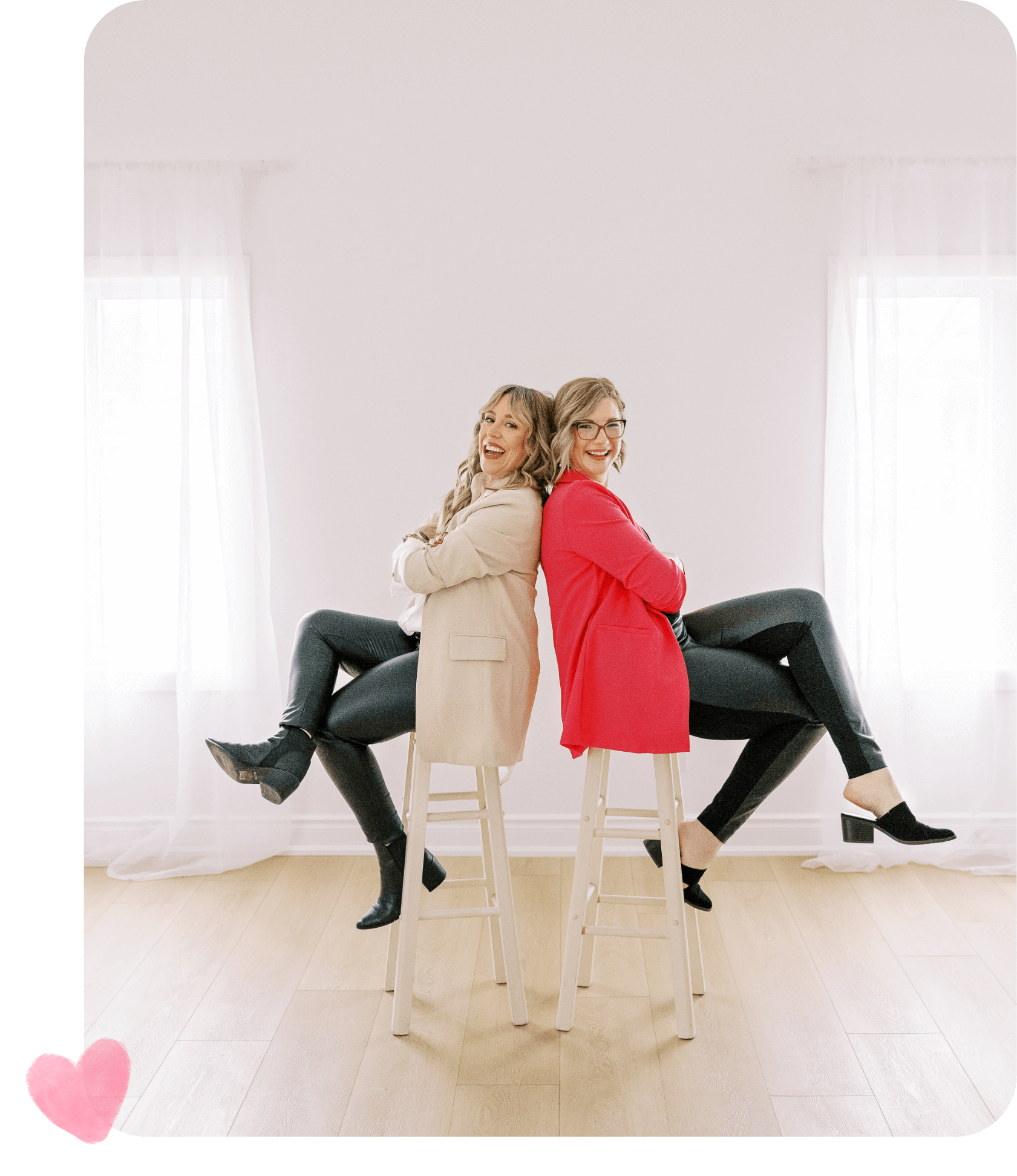 Owners of Freebird Beauty Co Candice and Lindsey posed sitting on chairs with their backs against each other