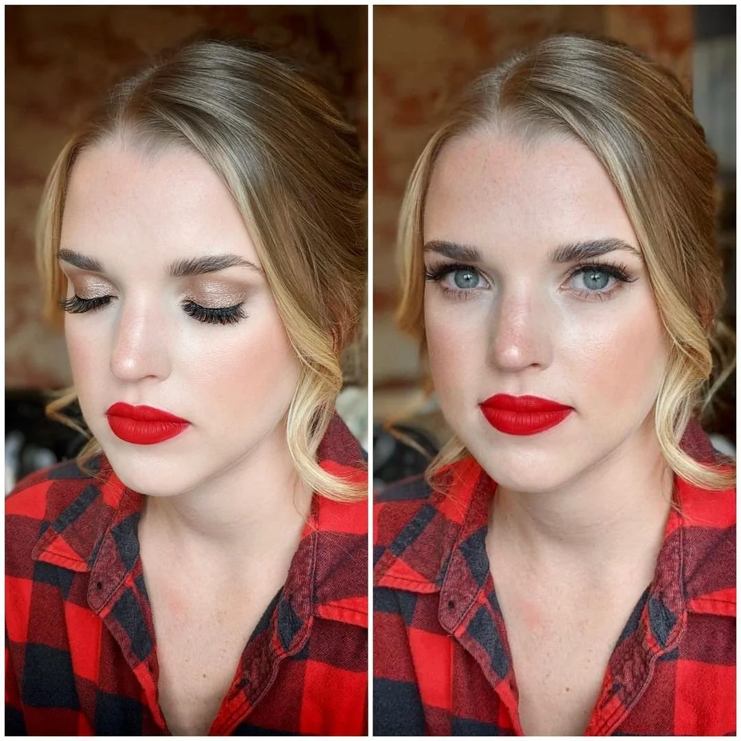 Woman with red lipstick and plaid shirt, showing eye makeup and hairstyle.