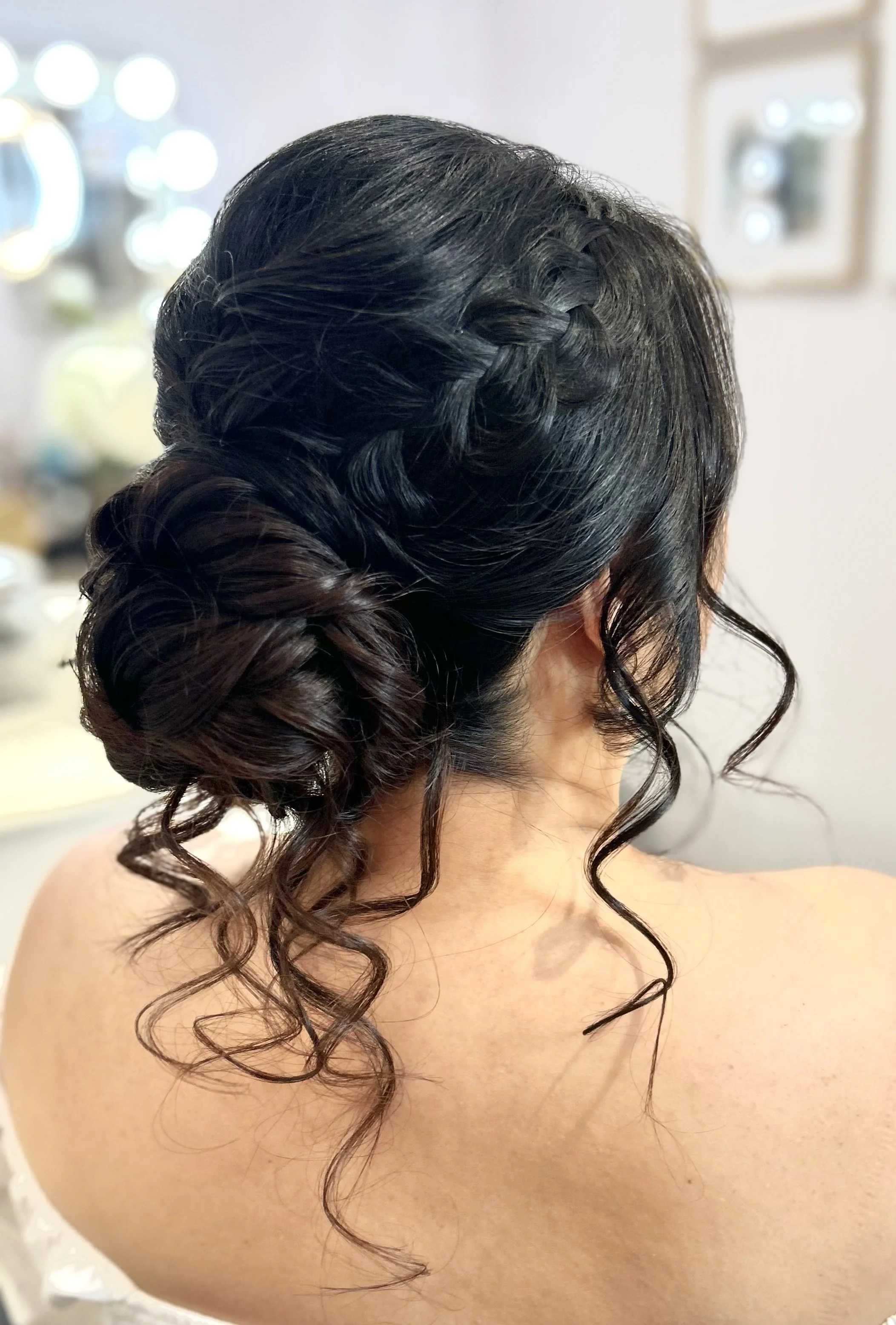 Woman with braided updo hairstyle and curls
