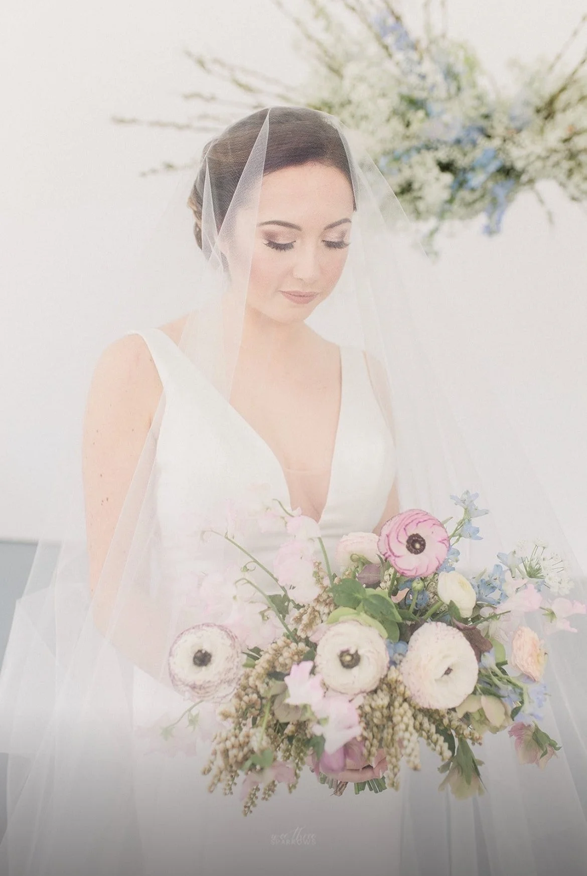Bride holding bouquet with veil