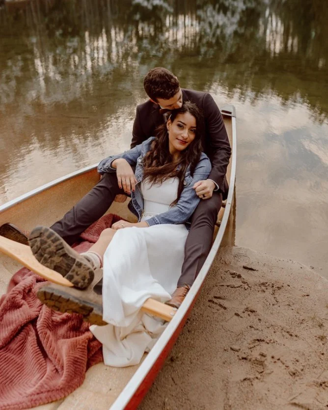 Couple sitting in a canoe on a calm lake