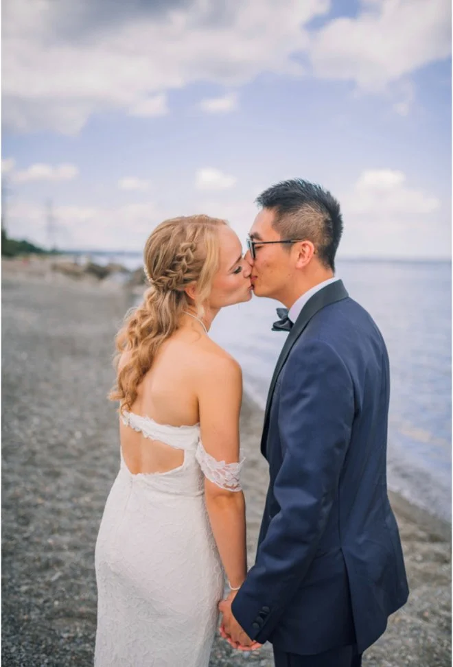 Bride and groom kissing on a beach