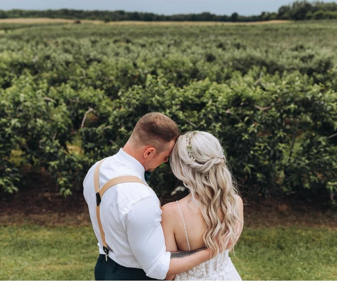 Couple embracing in front of vineyard