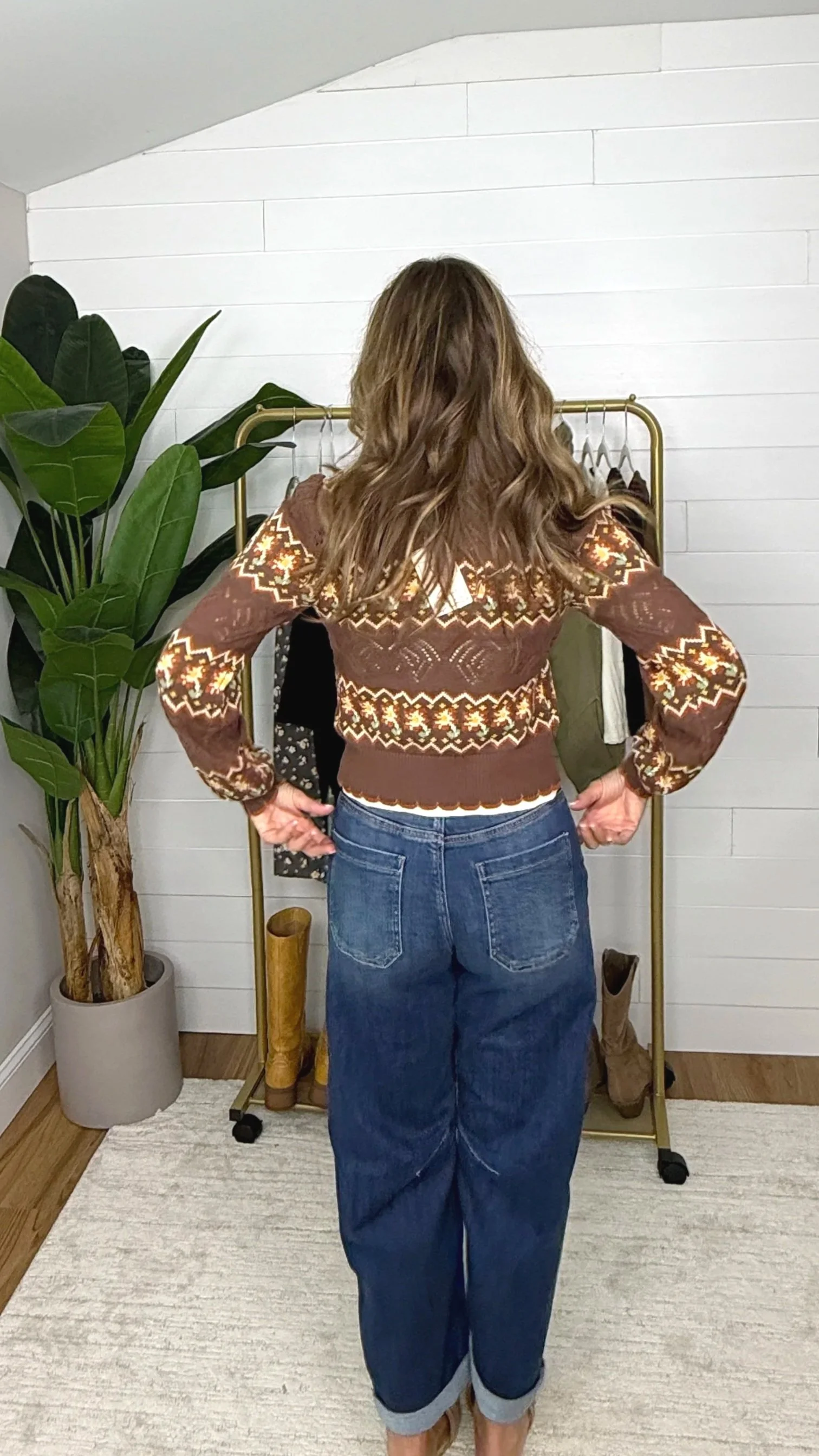 Back view of brown fair isle crochet cardigan showing mixed geometric and floral knit pattern