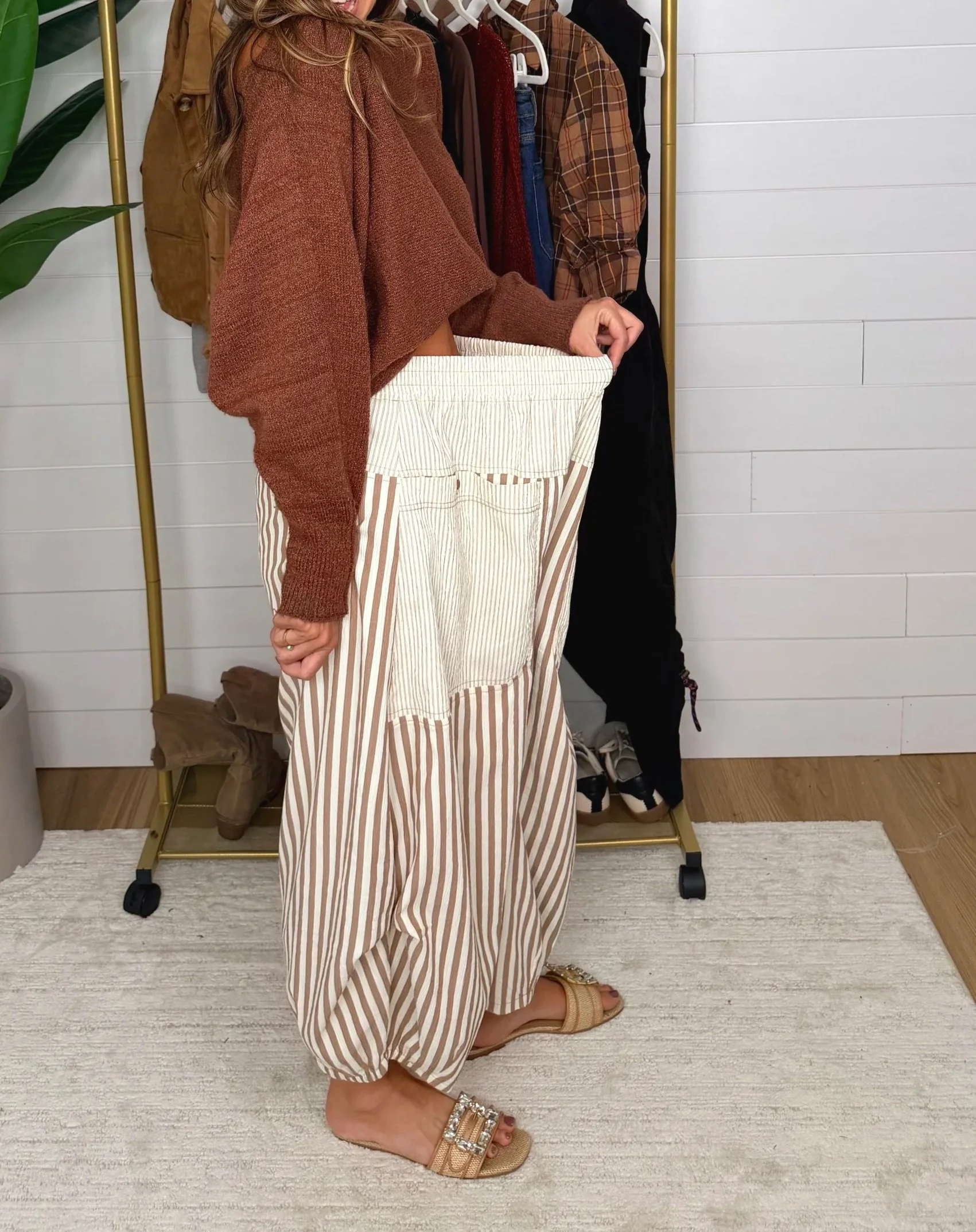 Close up of smocked elastic waistband on mocha mousse striped baggy pants