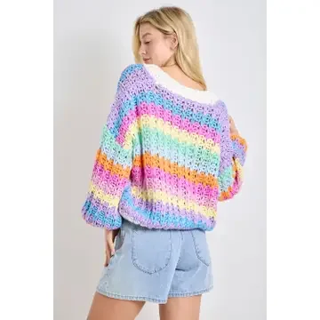 Back view of rainbow chunky knit cardigan showing cream trim and oversized balloon sleeves