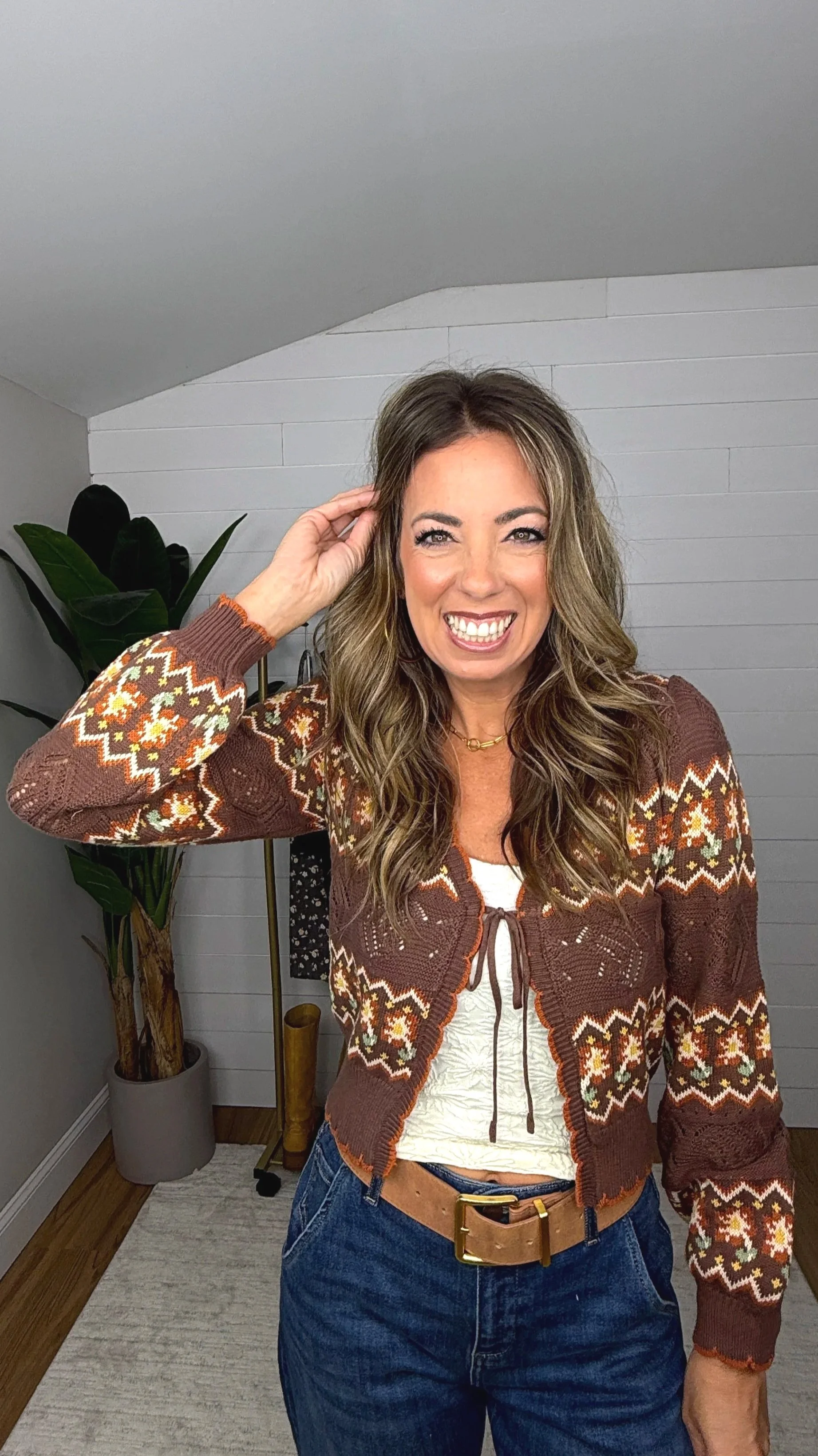 Close up front of brown fair isle crochet cardigan showing tie front closure and V neckline detail