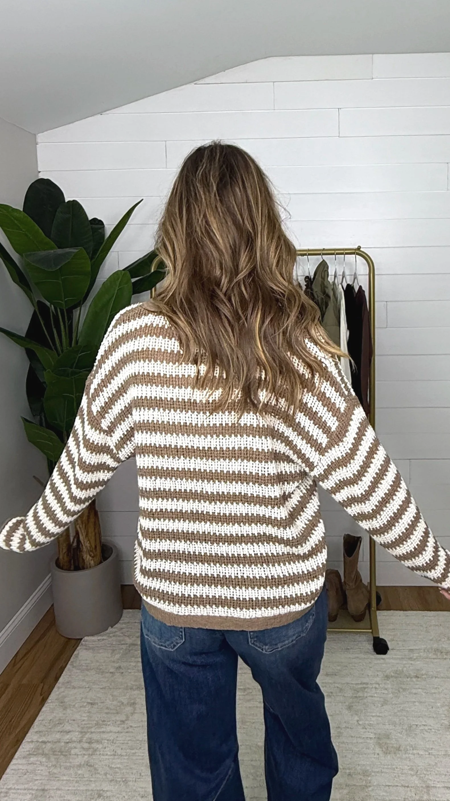 Back view of mocha cream stripe raw edge knit sweater showing full stripe pattern and relaxed fit