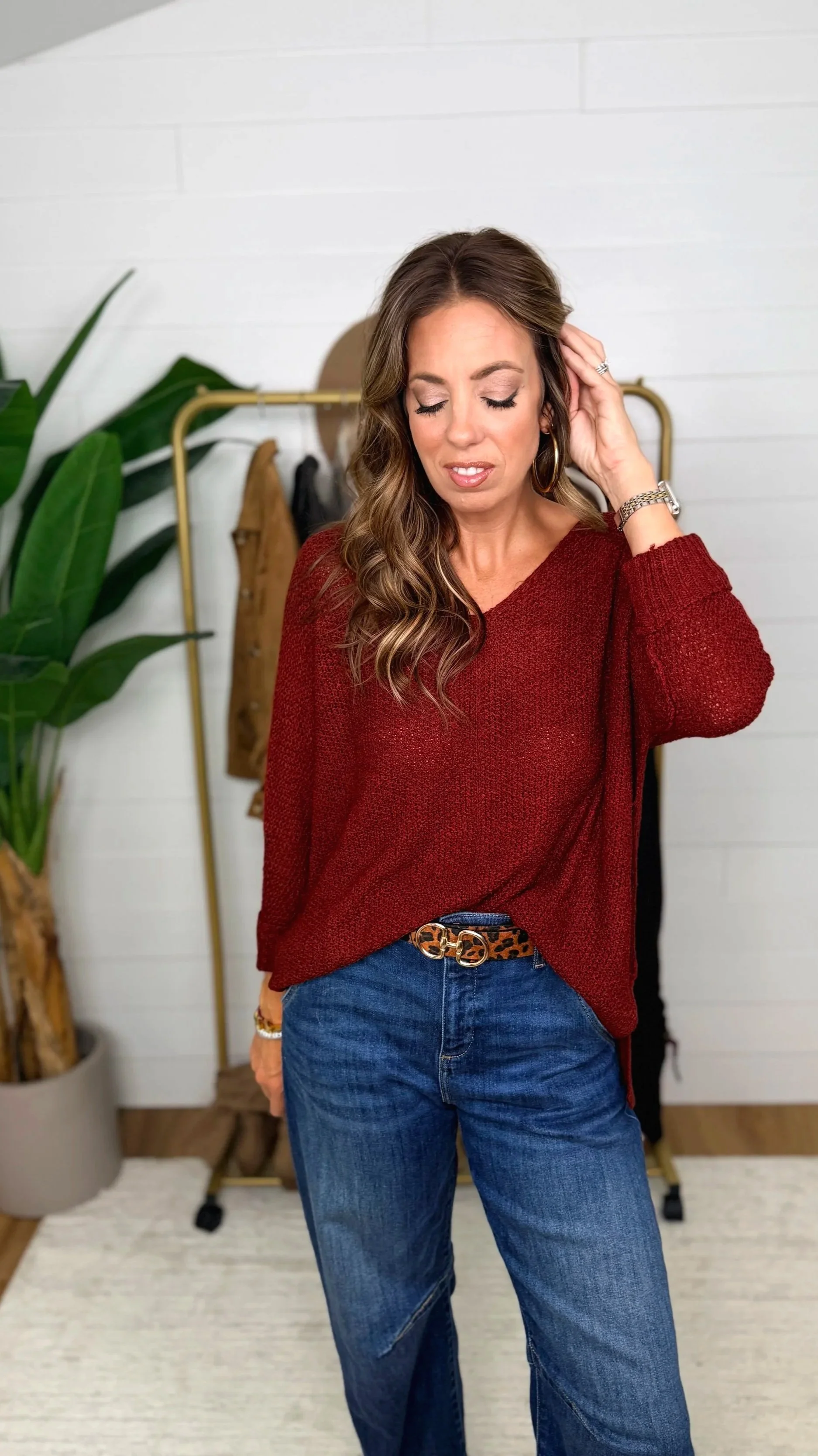 Close front view of wine v-neck knit sweater showing v-neckline and knit texture
