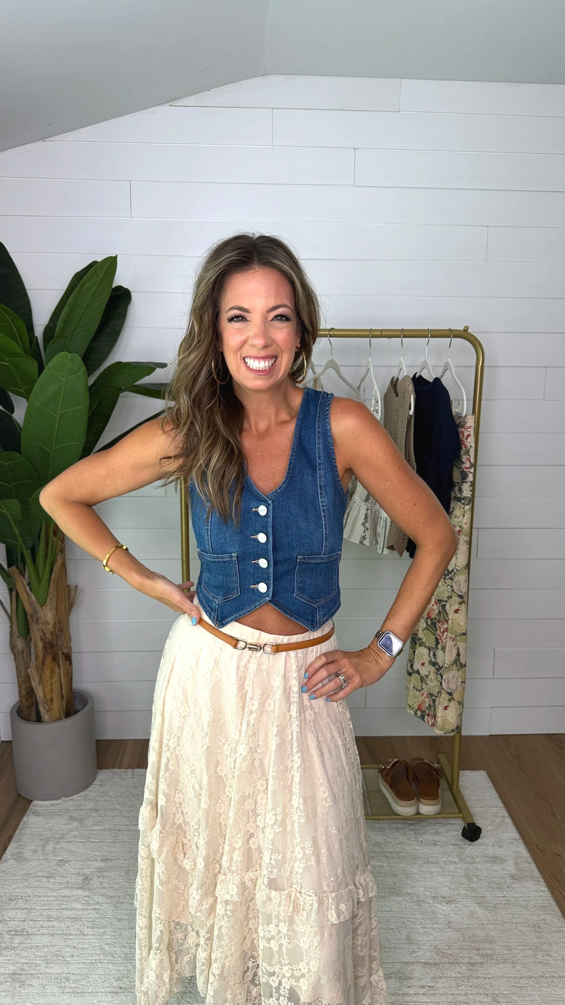 Full view of cream lace sharkbite midi skirt showing tiered ruffle layers and denim vest
