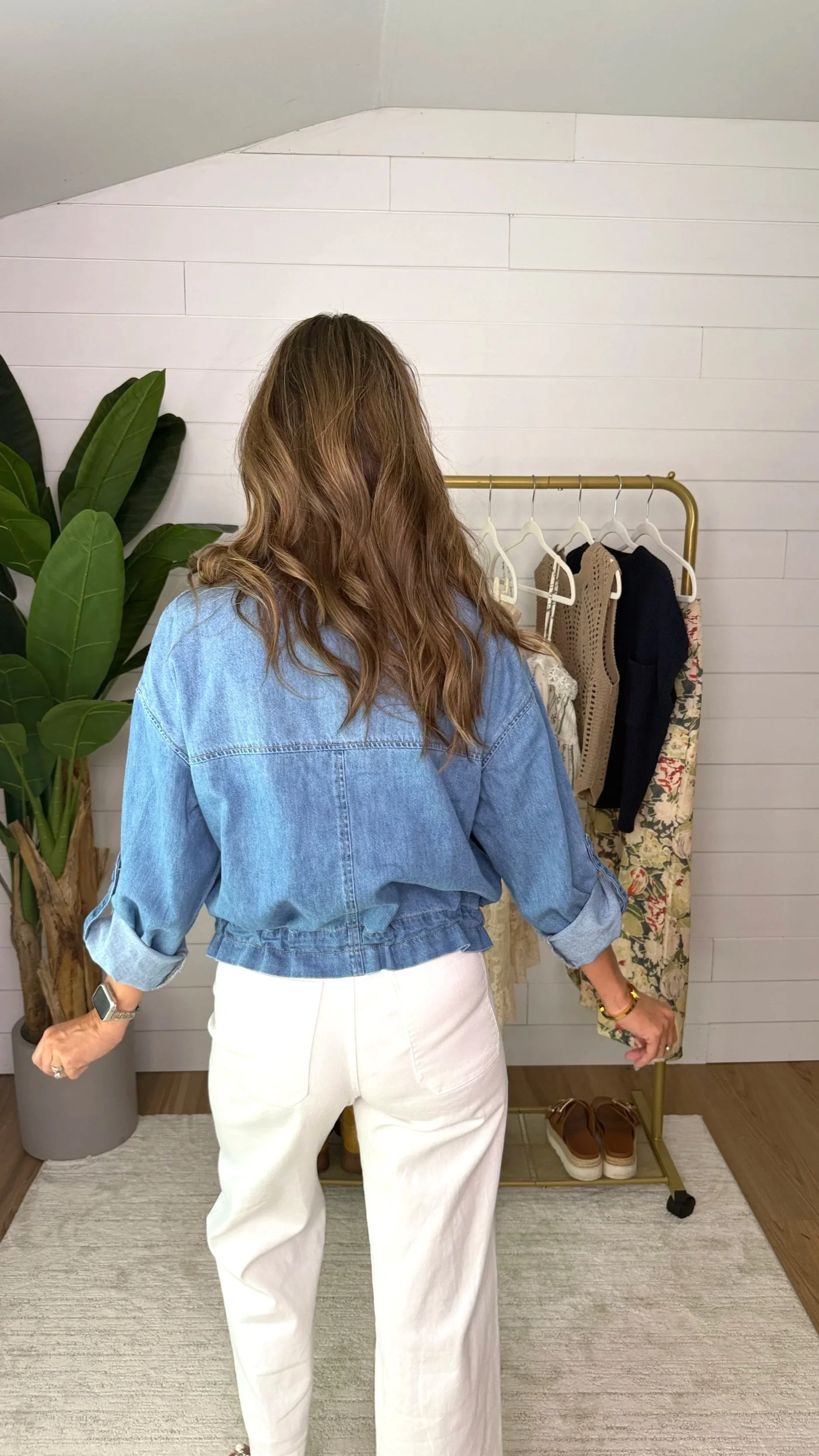 Back view of Risen oversized denim cargo jacket showing relaxed fit and rolled sleeves