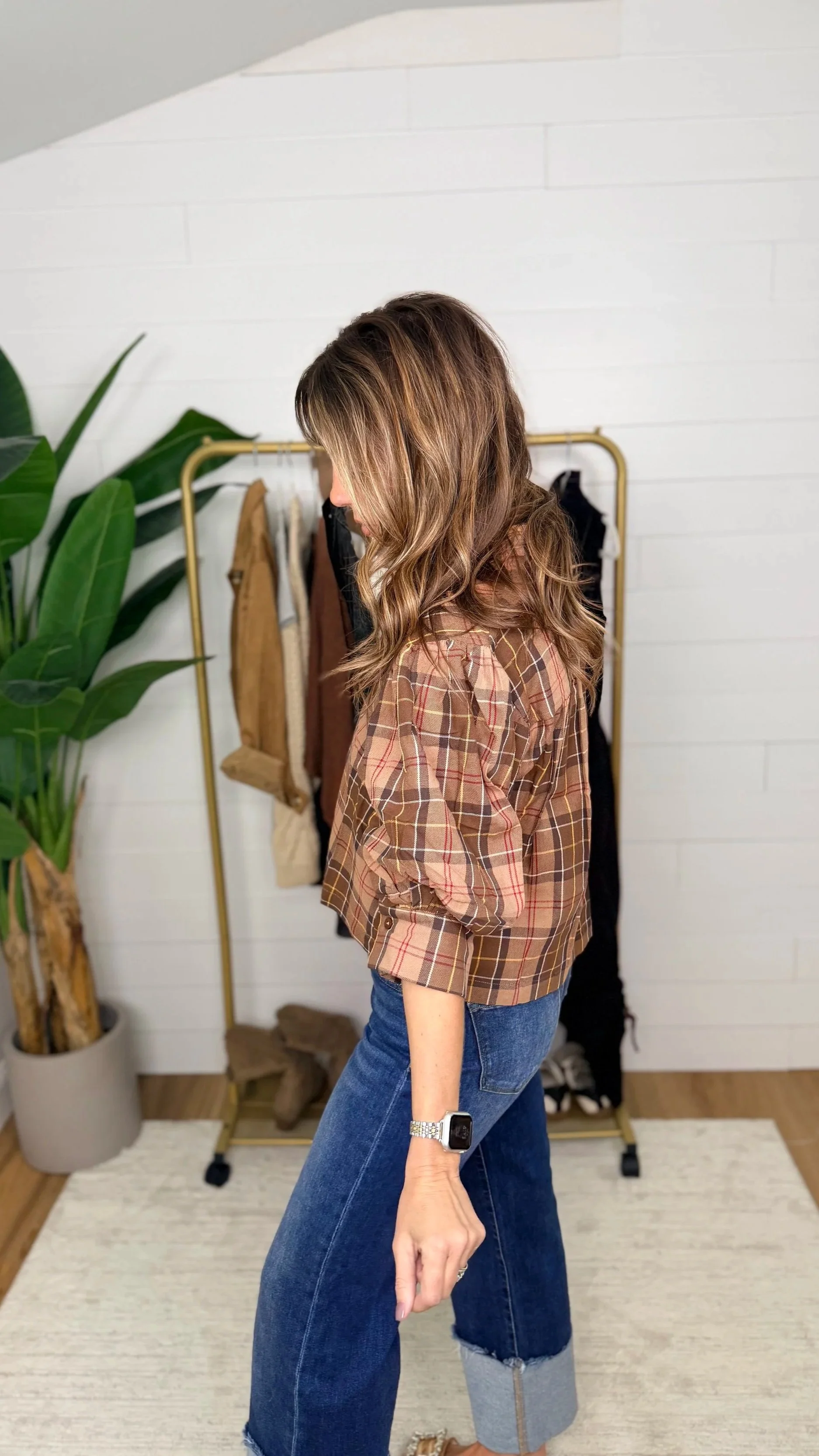 Side view of plaid button down blouse showing puff sleeve and cropped length