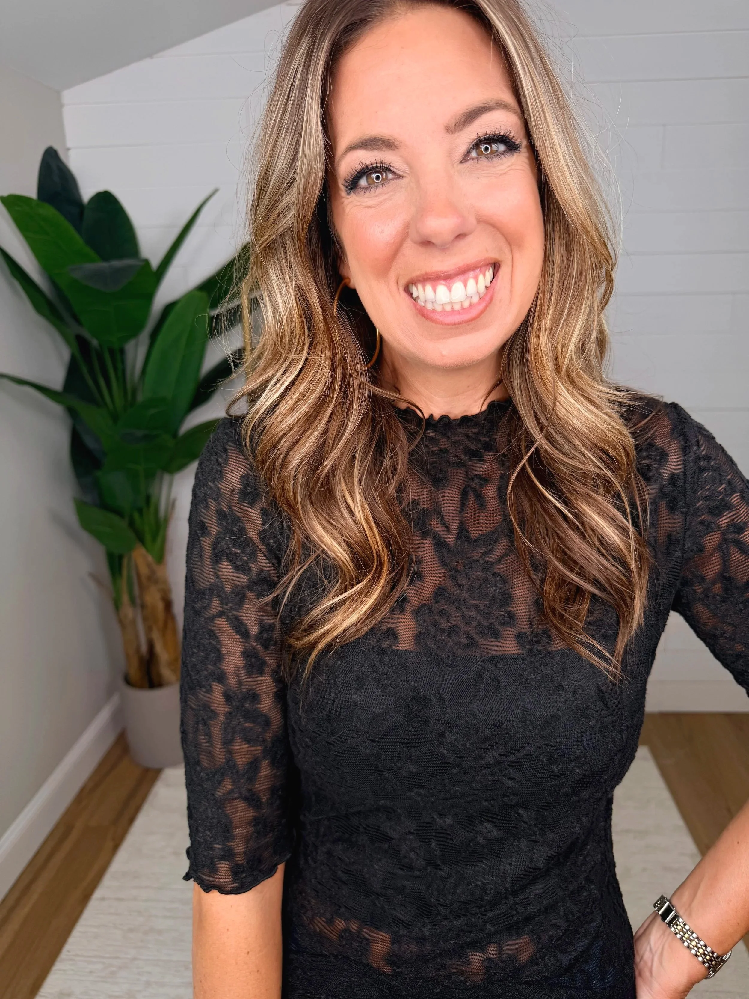 Detailed view of lace mock top in black floral print