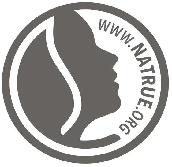 Logo featuring a side profile of a woman's face with flowing hair and a leaf, encircled by the text 'WWW.NATPURE.ORG'.