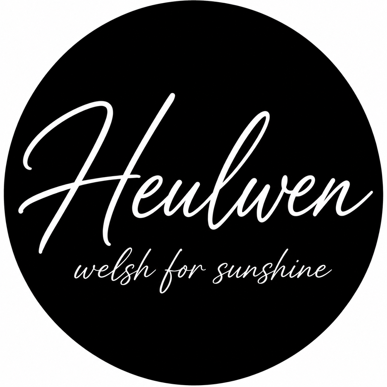 A black circular logo with the word "Heulwen" in large, white cursive letters and the phrase "welsh for sunshine" in smaller cursive letters below.