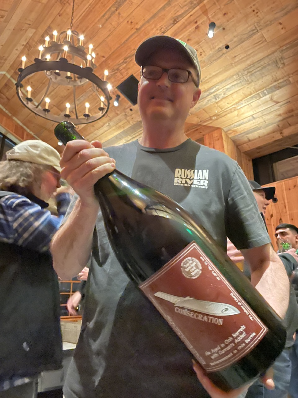Vinnie Cilurzo of Russian River holding a bottle of Consecration, a Russian River beer.