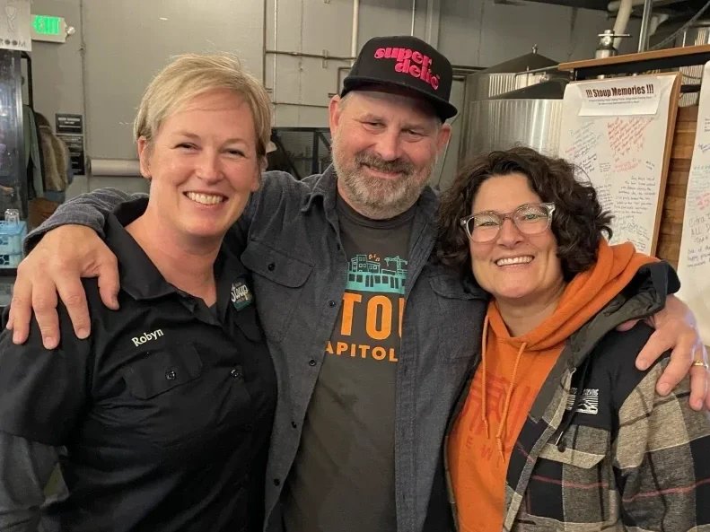 Brad Benson, Lara Zahaba, and Robyn Schumacher smiling and looking at the camera.