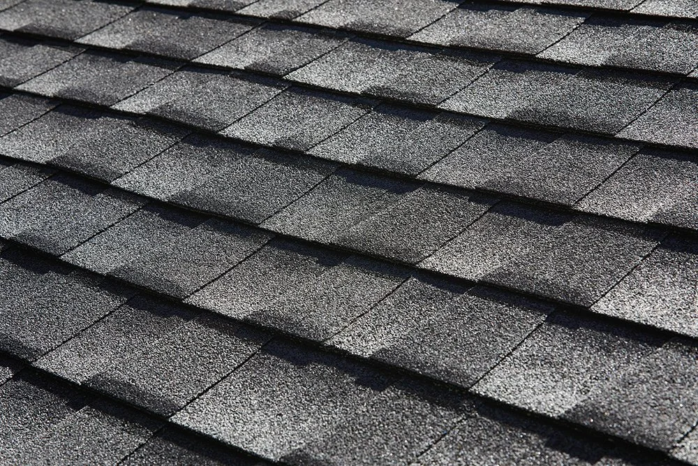 Close-up of a black asphalt shingle roof by National Roofing St. Louis after roof inspection and new construction roof of commercial building.
