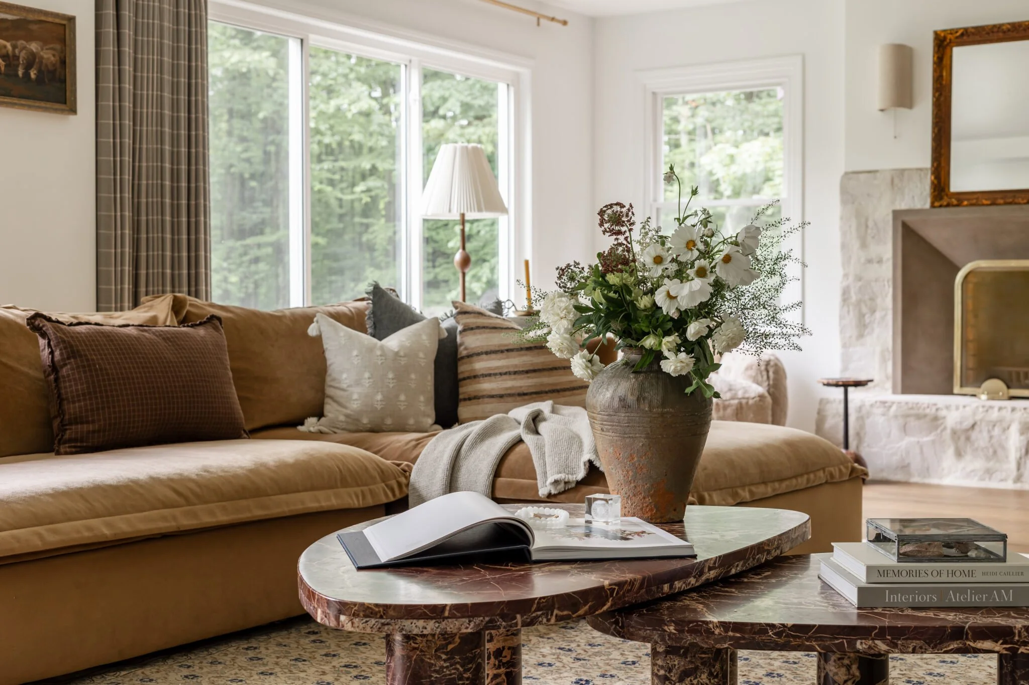 Leather sofa with assorted throw pillows and large textured vase in living room remodel and styling by S. Flynn Design + Build