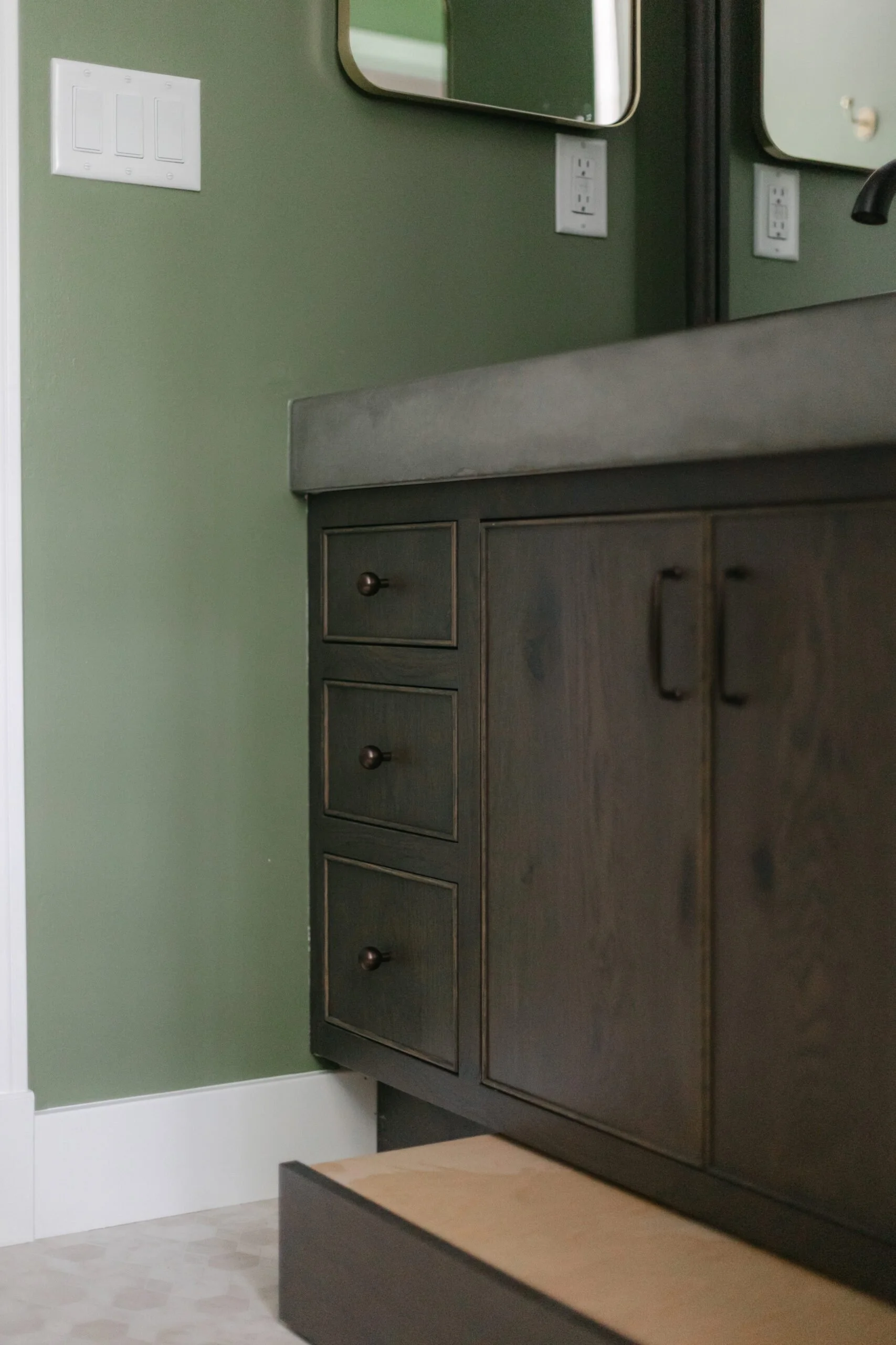 Dark brown wooden cabinets in bathroom remodel by S. Flynn Design + Build