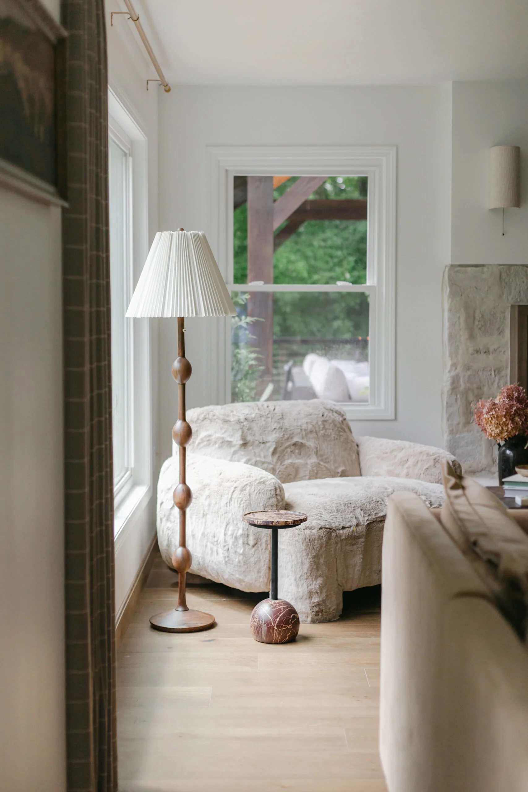 Soft and cozy furniture and wooden lamp styling in living room remodel by S. FLynn Design + Build