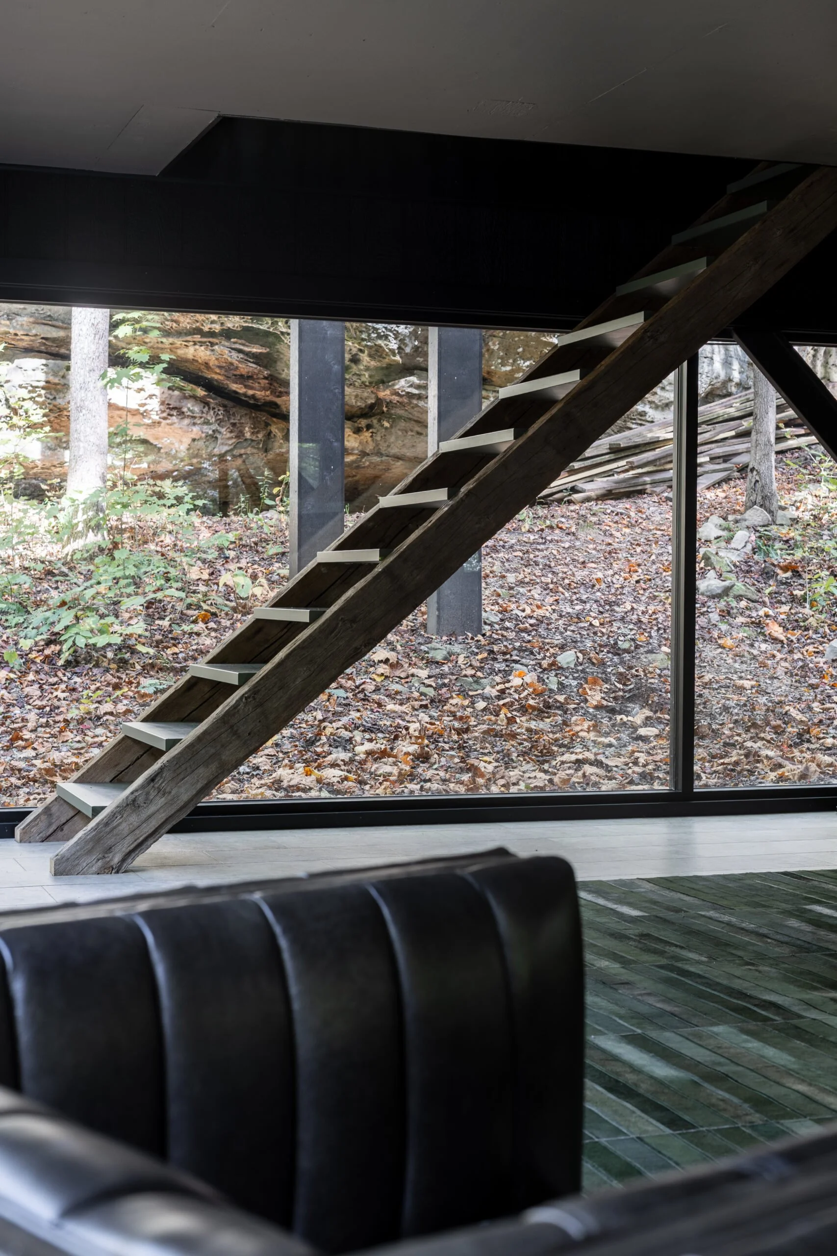Transformed basement remodel for modern living by S. Flynn Home featuring modern wooden staircase