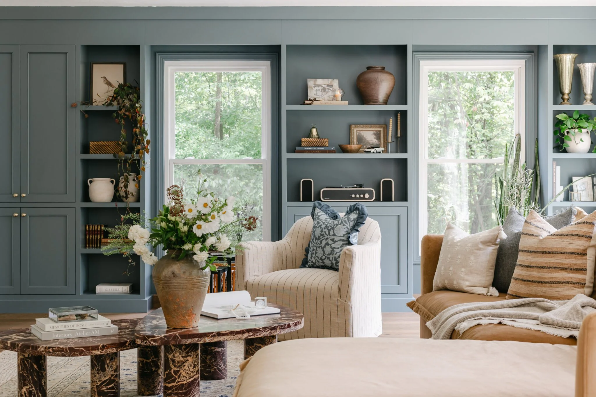 Blue built. in shelving and soft, cozy furniture and wooden lamp styling in living room remodel by S. FLynn Design + Build