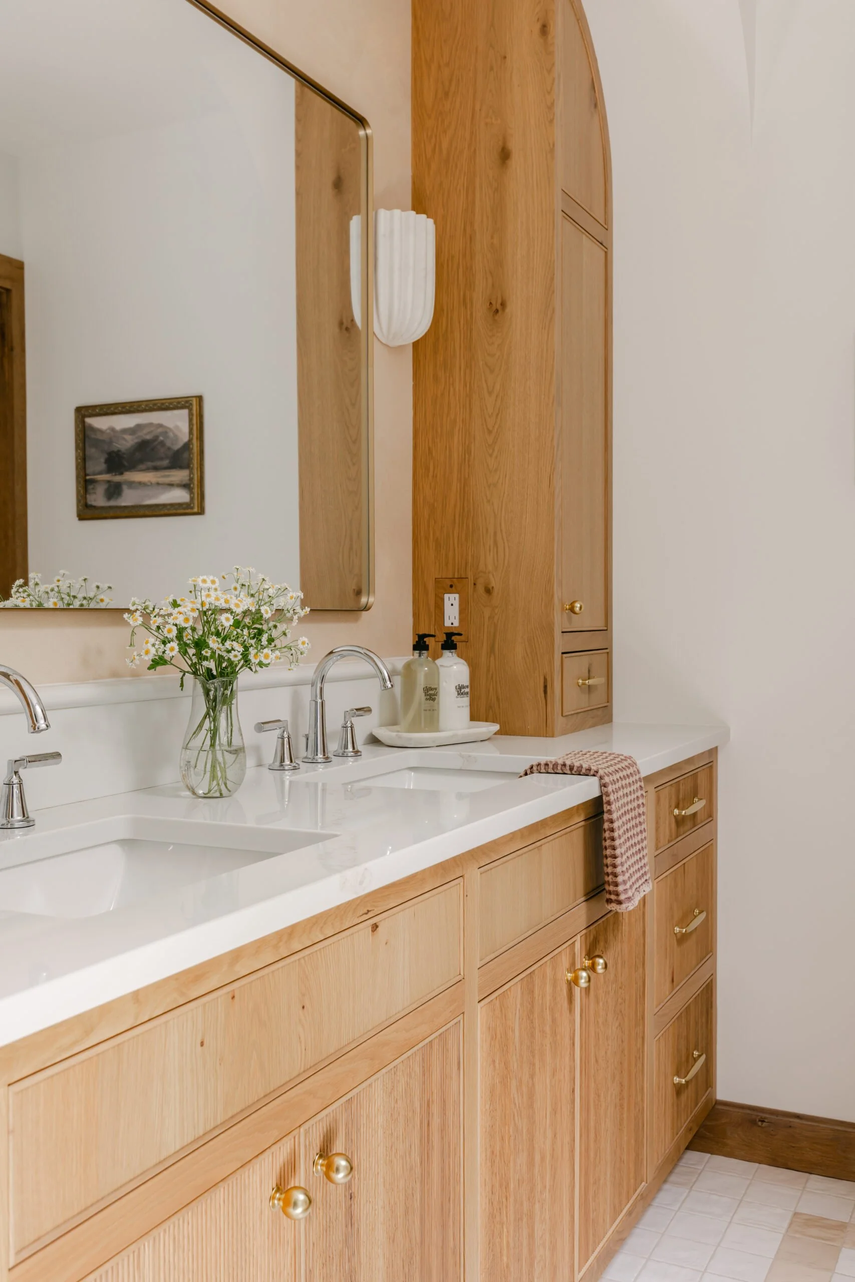 Warm brown cabinets with golden hardware in master bathroom remodel by S. Flynn Design + Build