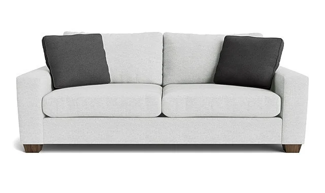 A light gray sofa with dark gray and black pillows