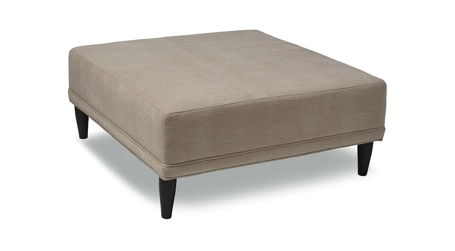 A beige upholstered ottoman with four black wooden legs.