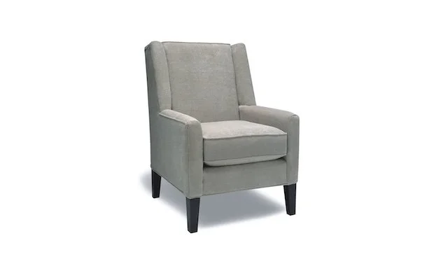 Gray upholstered armchair with black wooden legs.