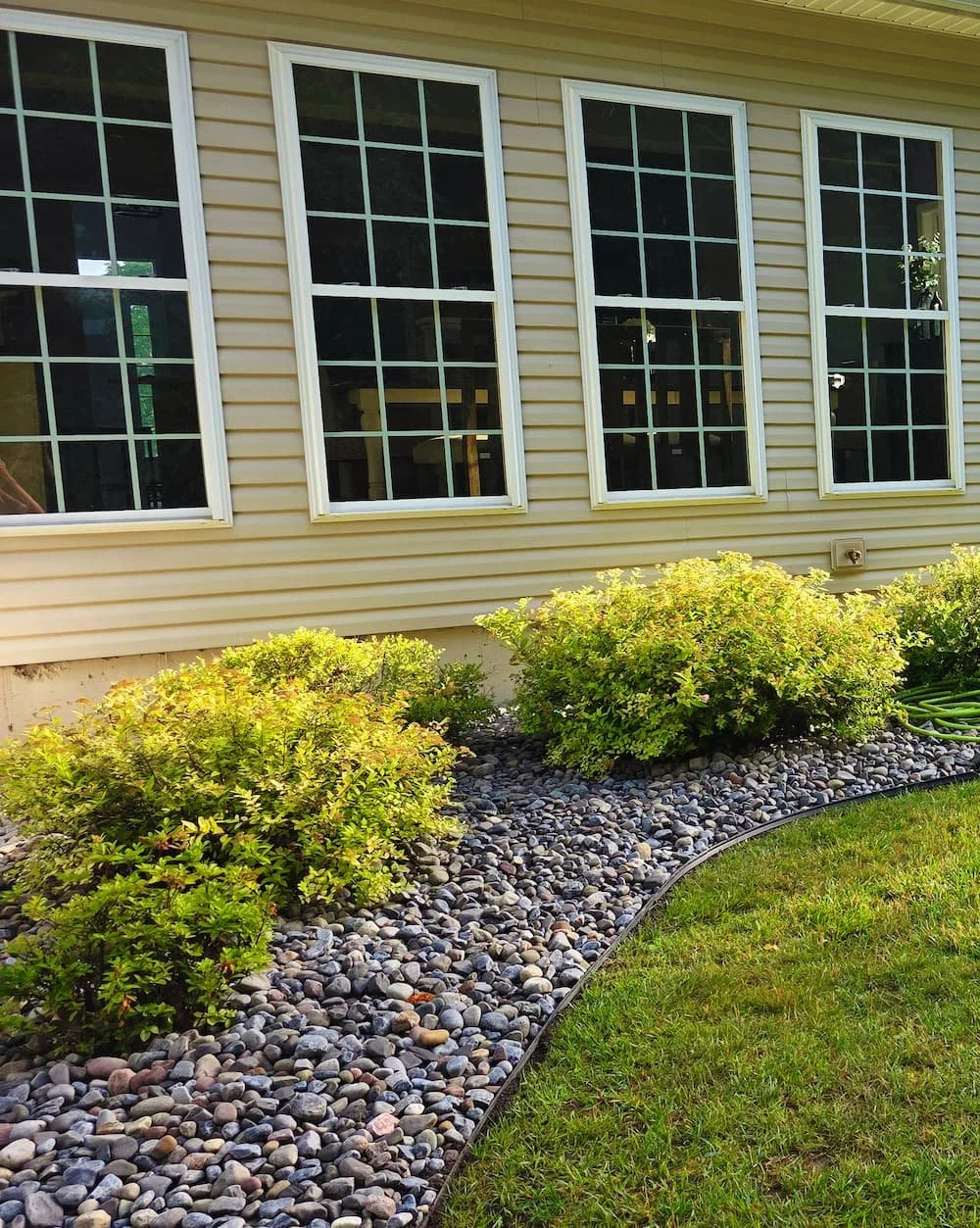 Custom paver patio creating an inviting outdoor living space beside a screened porch in Central NY.