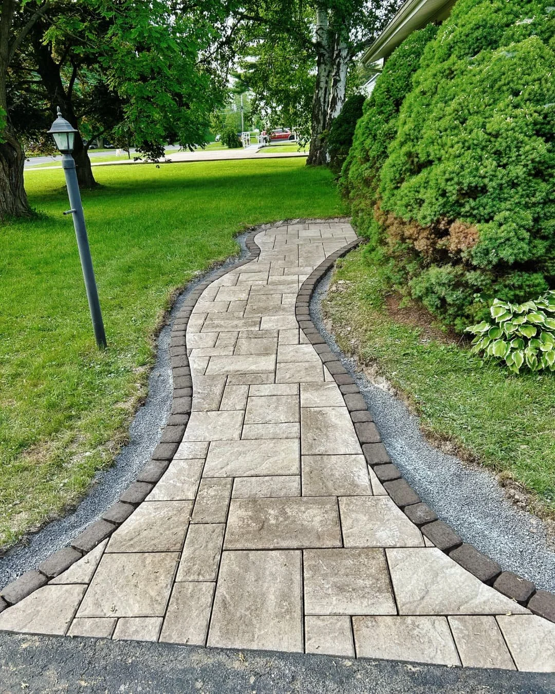 Curved front walkway before the project by Pines and Pavers in Central New York.