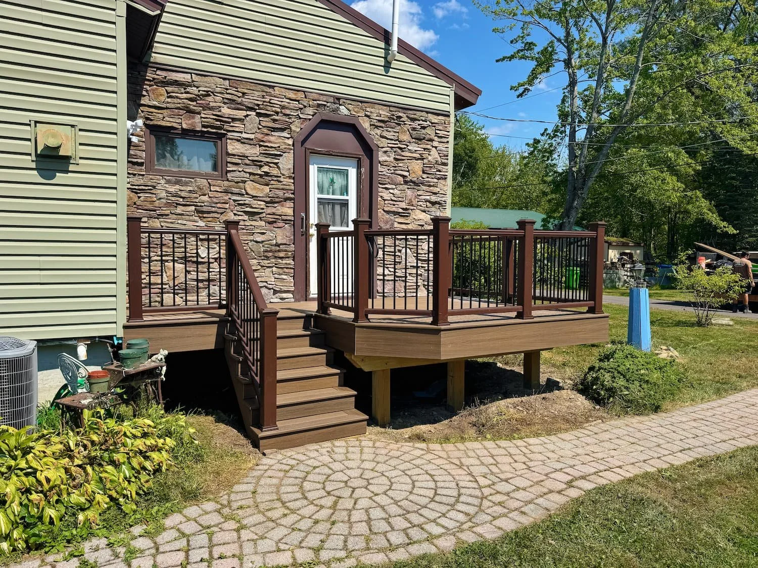 Finished composite deck renovation with stairs and railing at a Central New York home