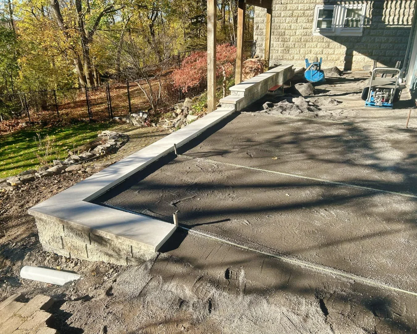 Existing deck and paver area before the outdoor renovation by Pines and Pavers in Central New York.