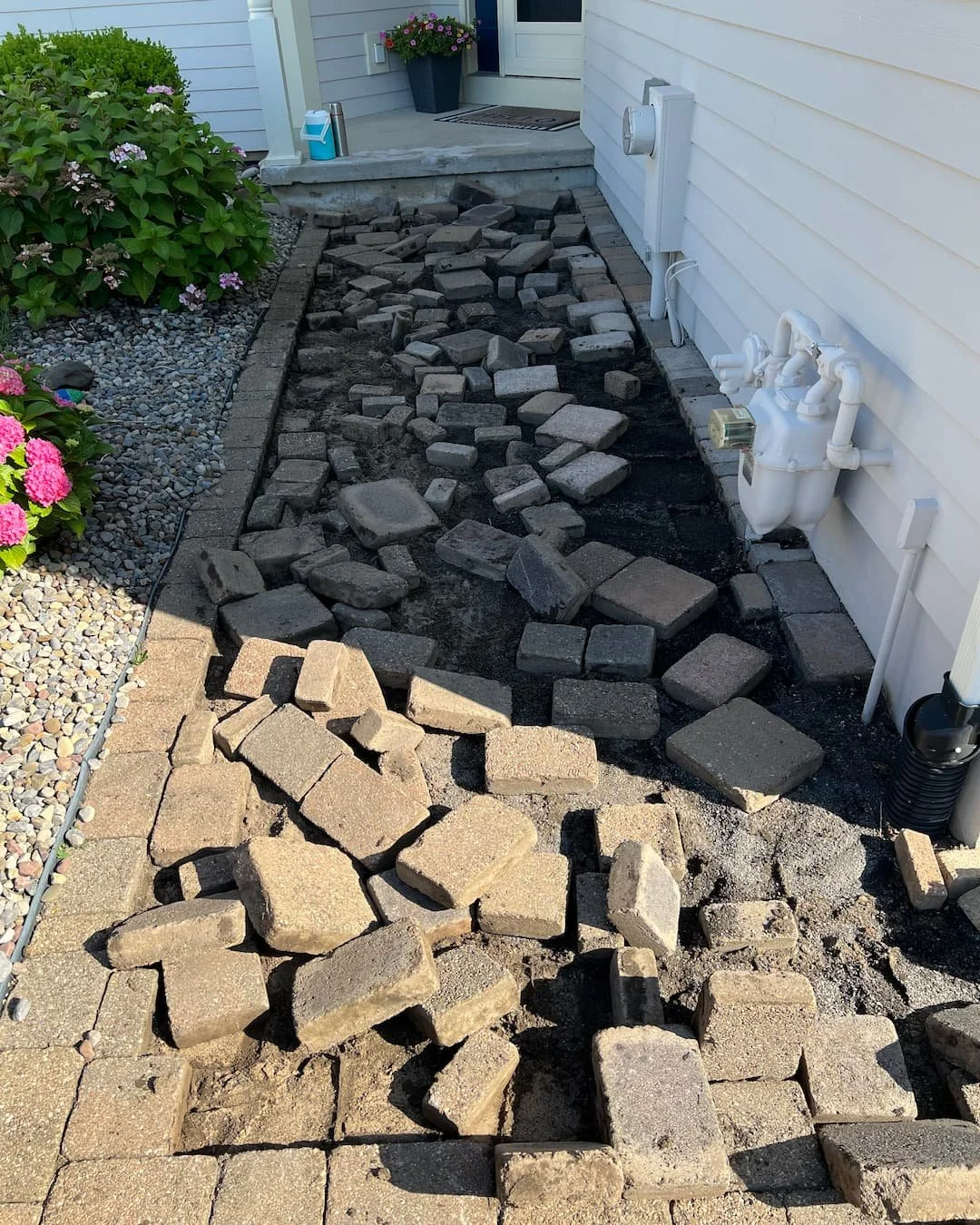 Front entry paver walkway installation in progress by Pines and Pavers in Fayetteville, New York.