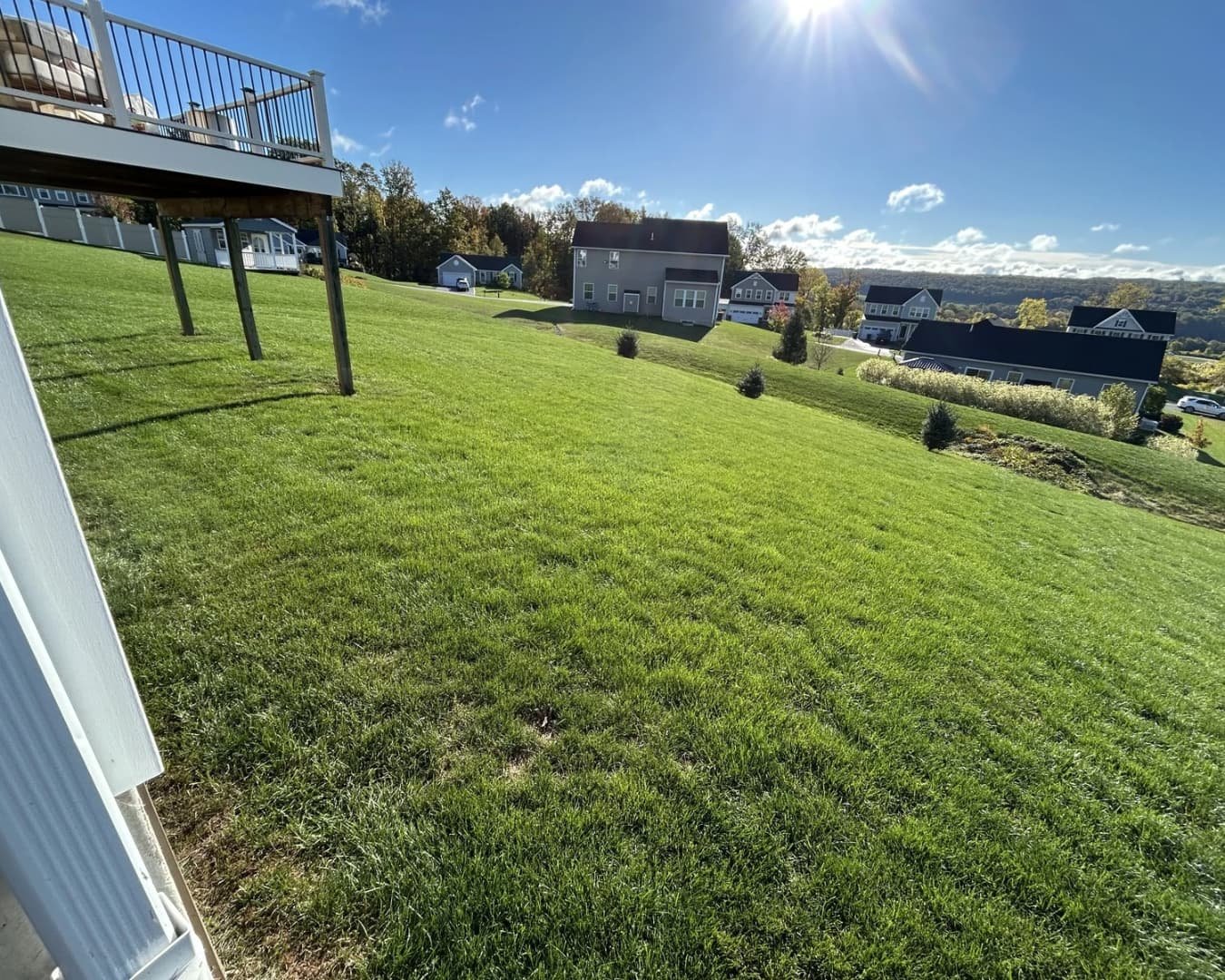 Compact equipment and active construction area at a Central New York hardscape installation.